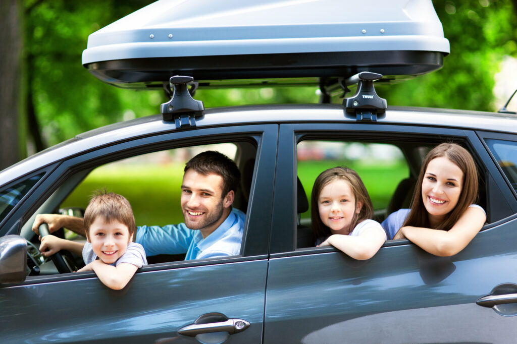 Happy family sitting in the car